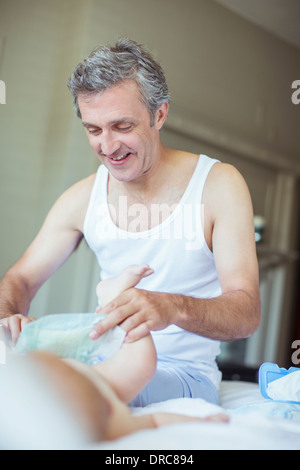 Father changing baby's diaper Stock Photo