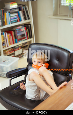 Boy talking on telephone Stock Photo