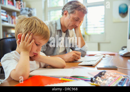 Father and son working in home office Stock Photo