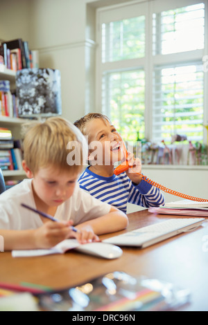 Boys working in home office Stock Photo