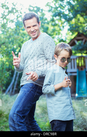 Father and son gesturing outdoors Stock Photo