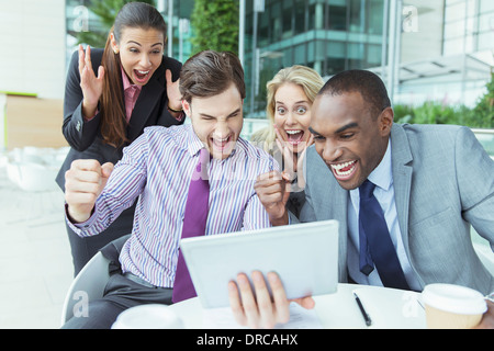 Business people cheering outdoors Stock Photo