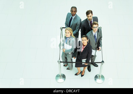 Business people standing in roped-off square Stock Photo