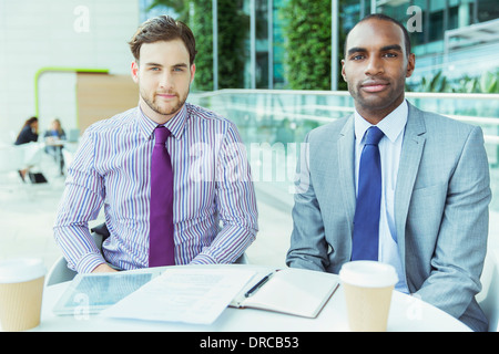Businessmen smiling in office Stock Photo