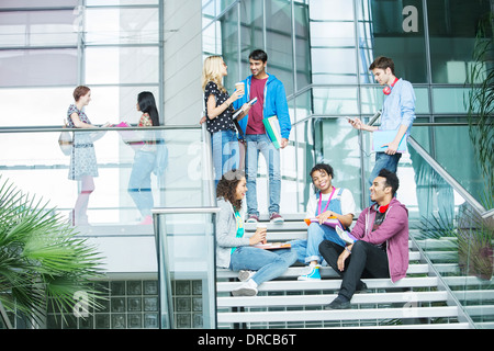 University students relaxing on steps Stock Photo