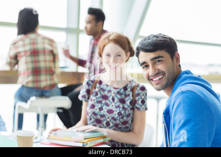 Students smiling in cafe Stock Photo