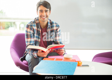 University student reading in lounge Stock Photo