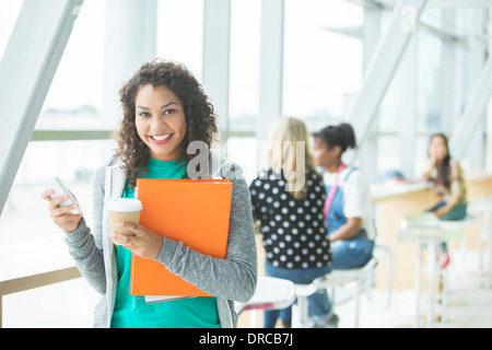 University student smiling in cafe Stock Photo