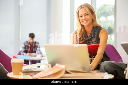 University student using laptop in lounge Stock Photo