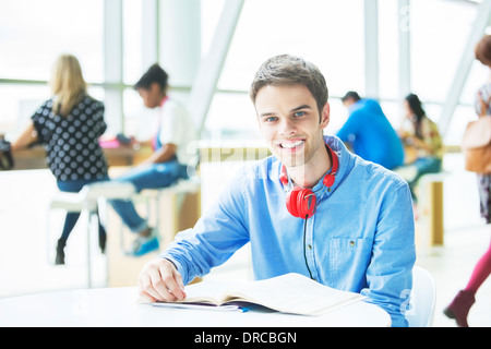 University student smiling in cafe Stock Photo