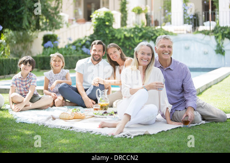 Multi-generation family enjoying picnic in backyard Stock Photo