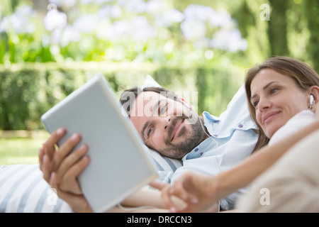 Couple using digital tablet outdoors Stock Photo