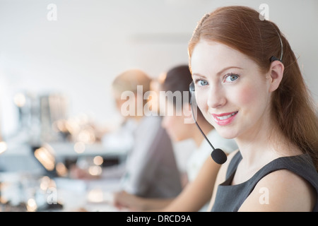 Businesswoman wearing headset in office Stock Photo