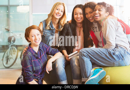 Women smiling together on beanbag Stock Photo