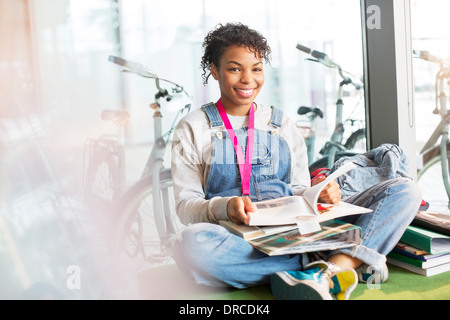 University student reading in lounge Stock Photo