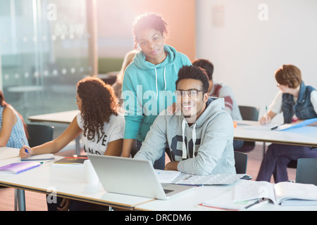 University students using laptop in classroom Stock Photo