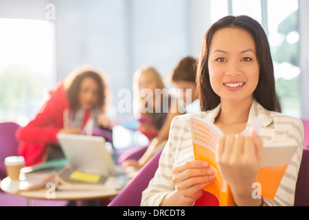 University student reading in lounge Stock Photo