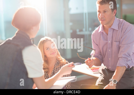 Professor and university students talking in classroom Stock Photo