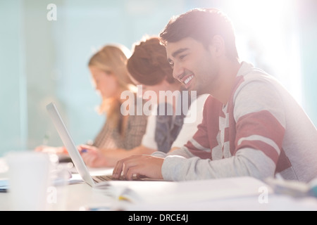 University student using laptop in classroom Stock Photo