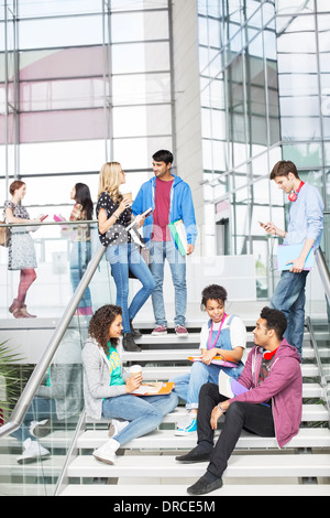 University students talking on steps Stock Photo