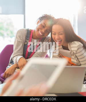 University students laughing in lounge Stock Photo