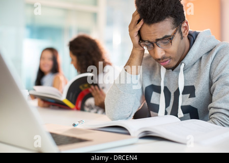 University student reading in classroom Stock Photo