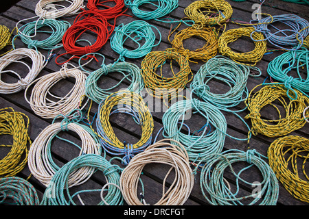 Coils of fishing rope on dock Stock Photo