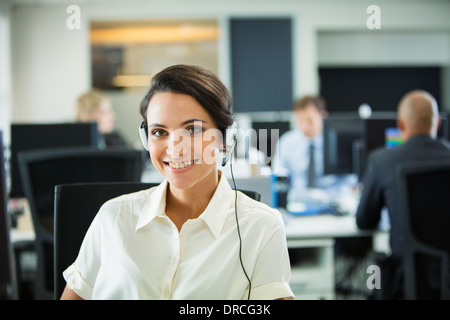 Businesswoman wearing headset in office Stock Photo