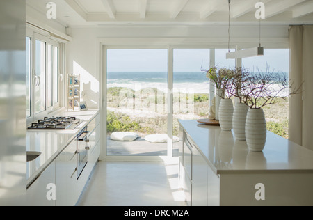 Modern white kitchen with ocean view Stock Photo