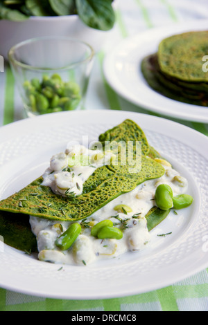 Green Pancakes with creamy fava beans. Stock Photo