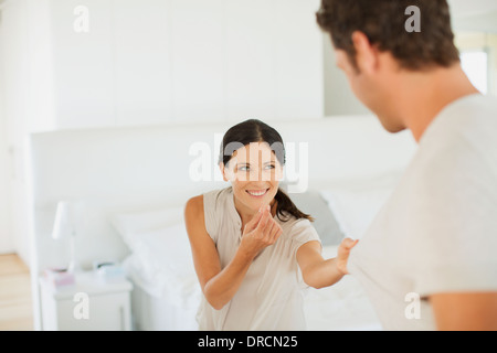 Couple playing together in bedroom Stock Photo