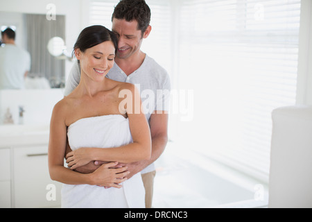 Couple hugging in bathroom Stock Photo