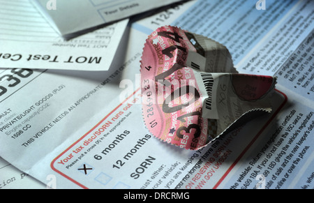 SCREWED UP CAR TAX DISC WITH DVLA DOCUMENTS RE MOTOR CAR TAXATION ENDING ENDS DISPLAY LICENCE SCRAPPED END OF EXCISE DUTY UK Stock Photo