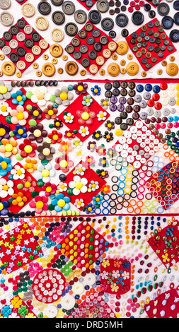 bright inventive crazy quilt display of every conceivable size & shape of button in window of fabric shop Oaxaca Mexico Stock Photo