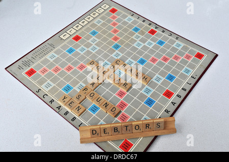 A scrabble board reflects the poor economic situation Stock Photo