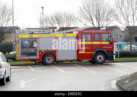 Fire Engine at speed on a shout in Bradley Stoke, Bristol, England, UK. January 2014 Stock Photo