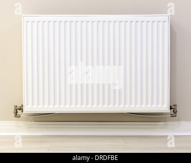 full view of a white radiator against a cream wall Stock Photo