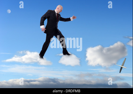 a businessman stepping on clouds Stock Photo