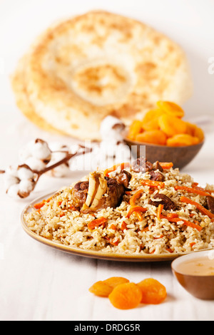 Uzbek national dish pilaf on plate Stock Photo