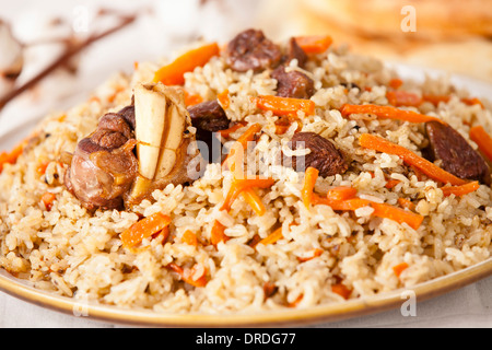 Uzbek national dish pilaf on plate Stock Photo