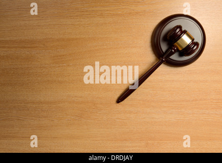 A gavel isolated on a wood table Stock Photo