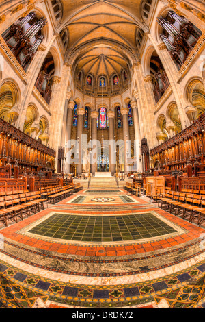 The altar, chancel, and choir seating area inside the Cathedral of Saint John the Divine in New York City. Stock Photo