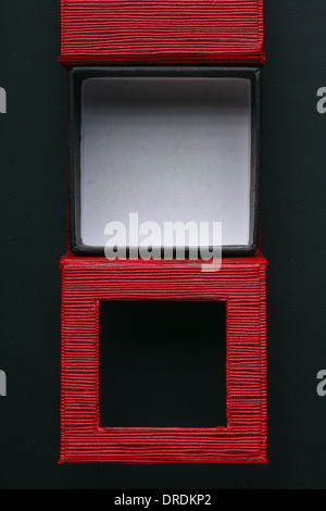 Red black rectangular ring jewellery box on dark background Stock Photo