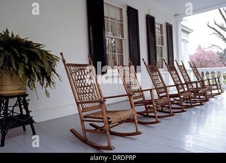 Rocking chairs made of wood and wicker await visitors on the front