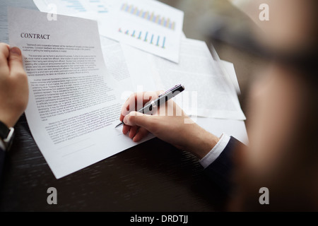Image of businessman hand with pen signing contract Stock Photo