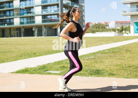 A beautiful young woman making some exercise at the park - fitness concept Stock Photo