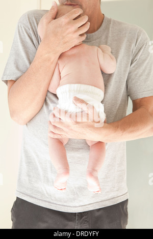 New dad holding baby in a diaper Stock Photo