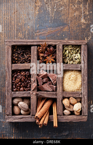 Assortment of spices and coffee beans in wooden box Stock Photo