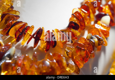 Macro photo of orange amber beads on white background Stock Photo