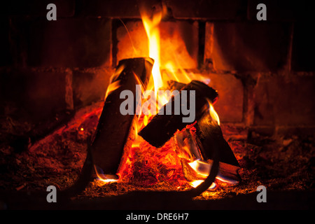 Natural photo background with fire in dark fireplace Stock Photo